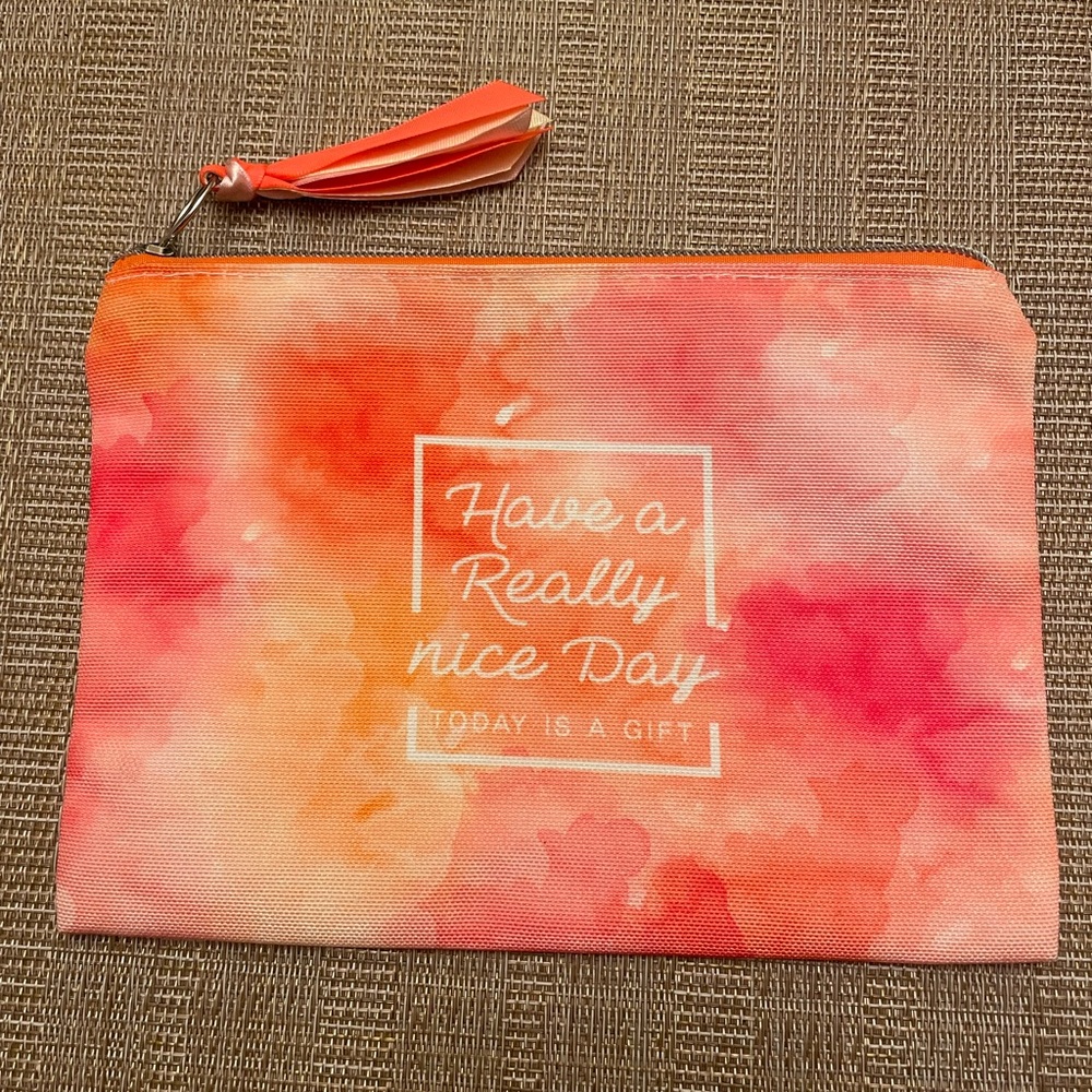 Watercolor pink/orange zippered cosmetic case with fun tasseled pull NWOT